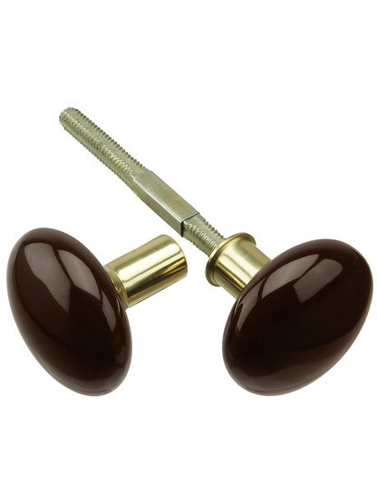 Pair of Brown Porcelain Rim Lock Knobs With Solid Brass Shanks in Polished Brass.